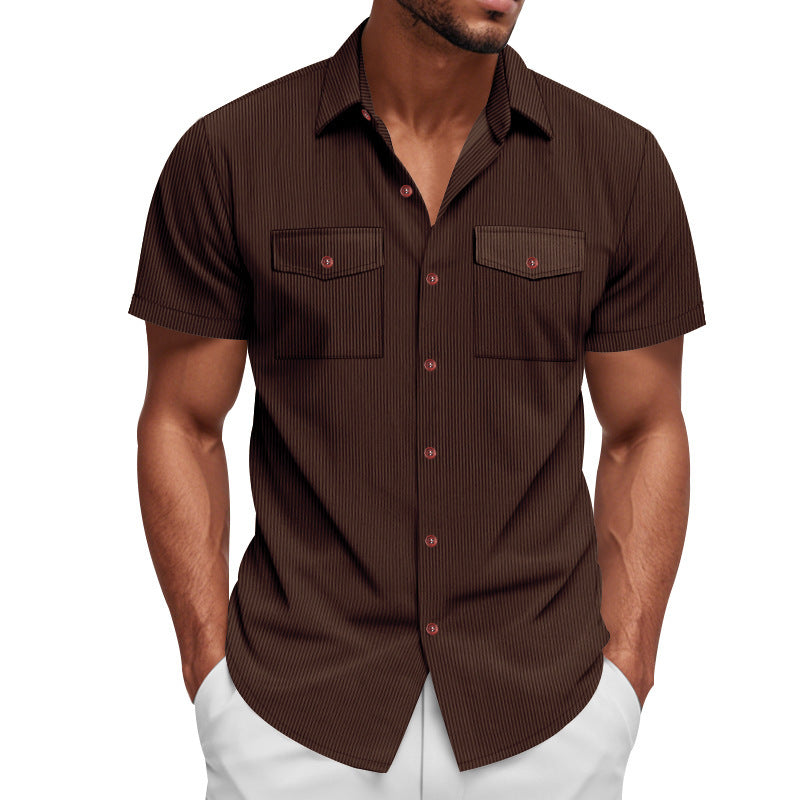 Man wearing a brown short-sleeve shirt with white pants on a white background