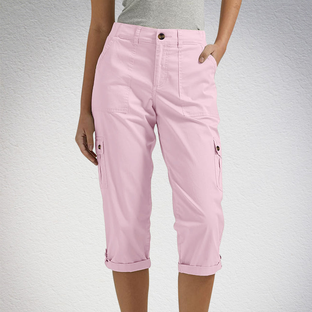 Pink cargo pants worn by a person on a light gray background