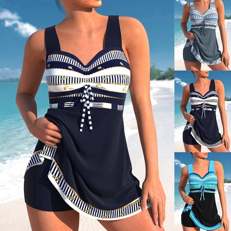 Woman wearing a navy blue and white patterned tankini with a beach background