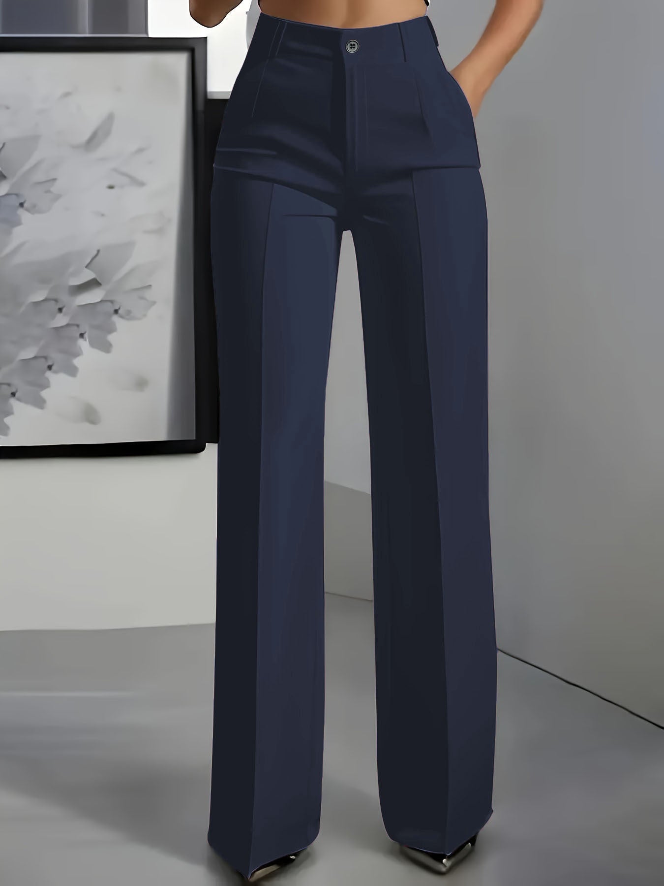 Navy blue pants worn by a person against a neutral background
