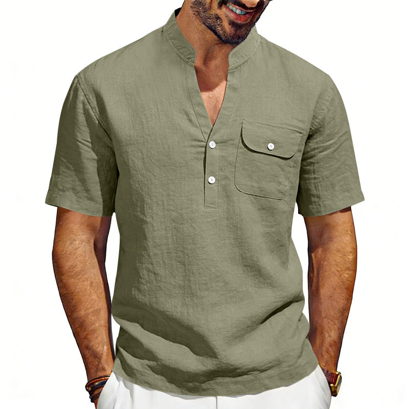 Man wearing a green short-sleeve shirt with a pocket on a white background