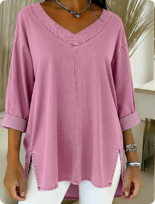 Pink blouse worn by a person with a neutral background