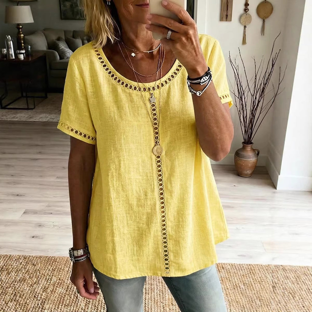 Person wearing a yellow top with decorative buttons in a living room setting.