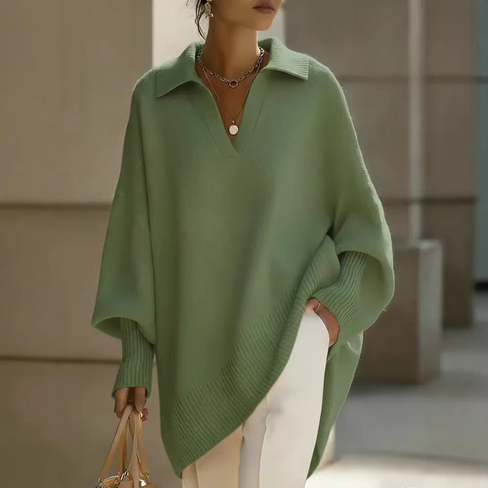 Person wearing a green poncho with a neutral background