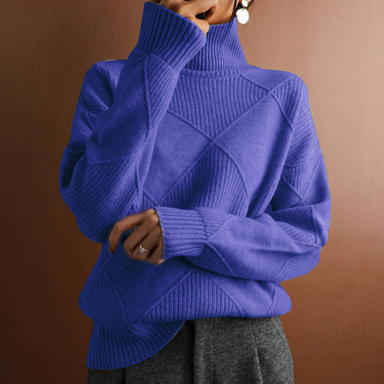 Blue knitted sweater worn by a person against a brown background