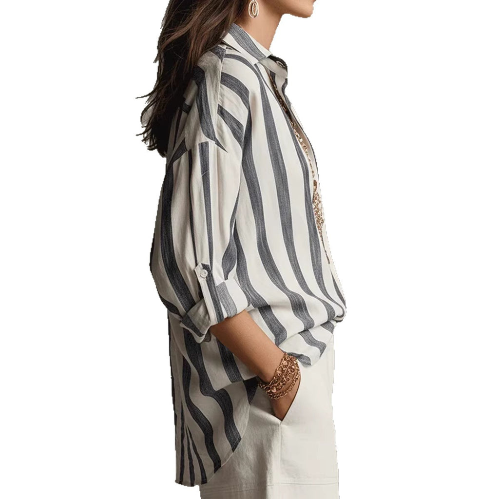 Woman wearing a striped shirt with a plain background