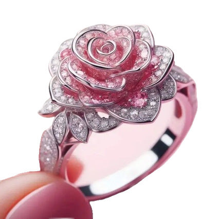 Pink rose-shaped ring with gemstones on a white background