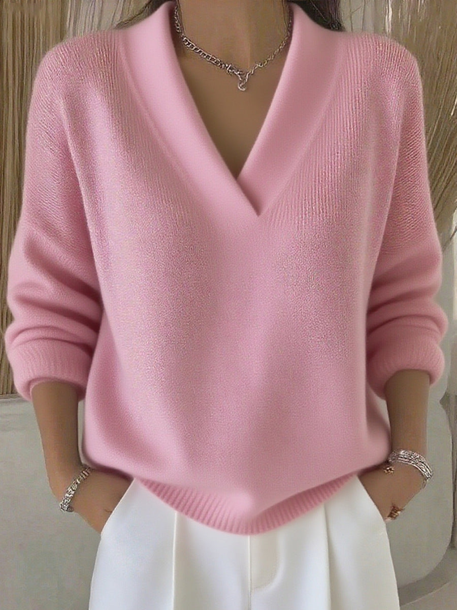 Pink sweater worn by a person with a neutral background