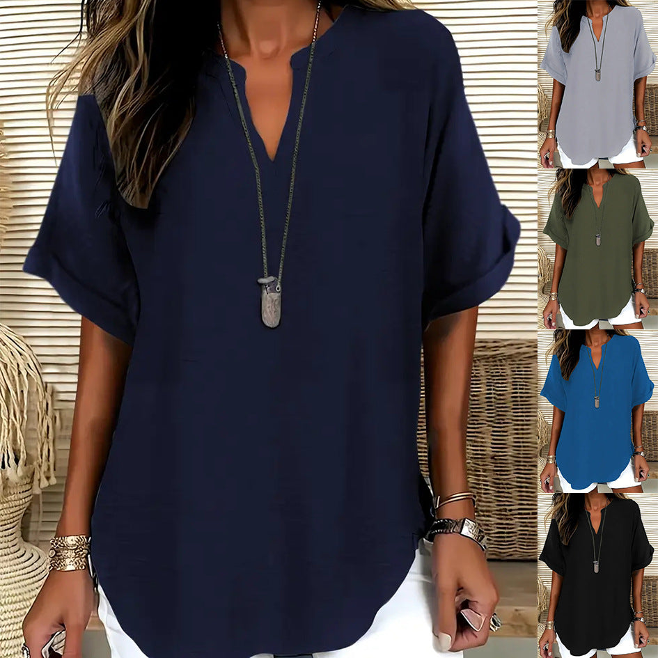 Woman wearing a navy blue blouse with a necklace, surrounded by color swatches of other blouses.