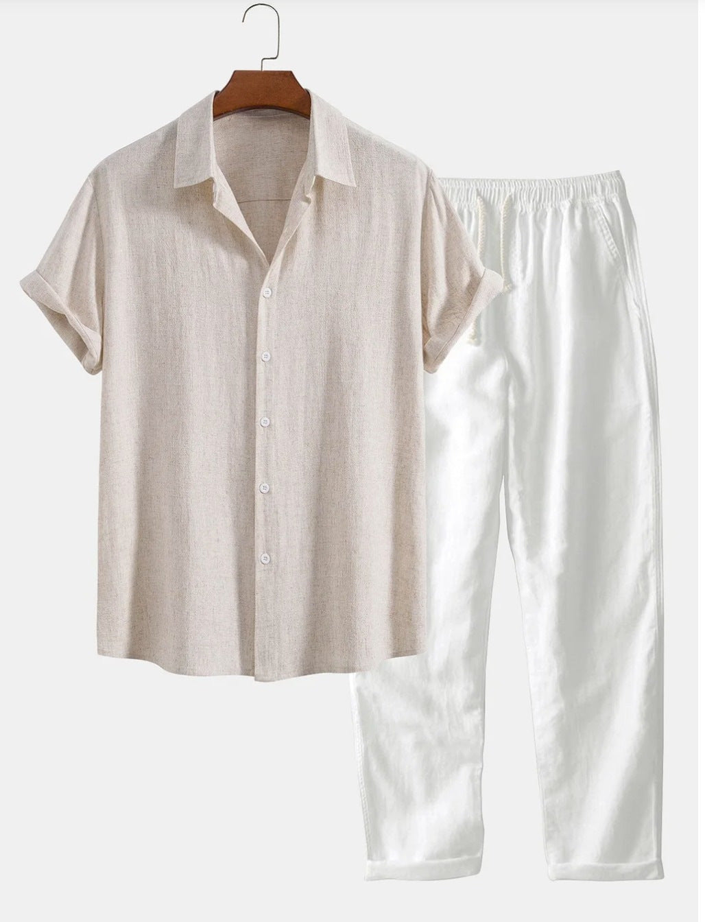 Beige shirt and white pants on a hanger against a white background