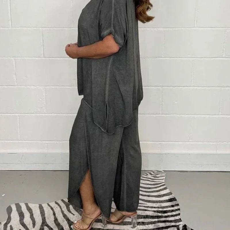 Woman wearing loose dark grey matching set from ZA-Zola, posing by a zebra print rug