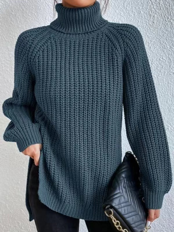 Person wearing a dark blue knitted sweater against a light gray background
