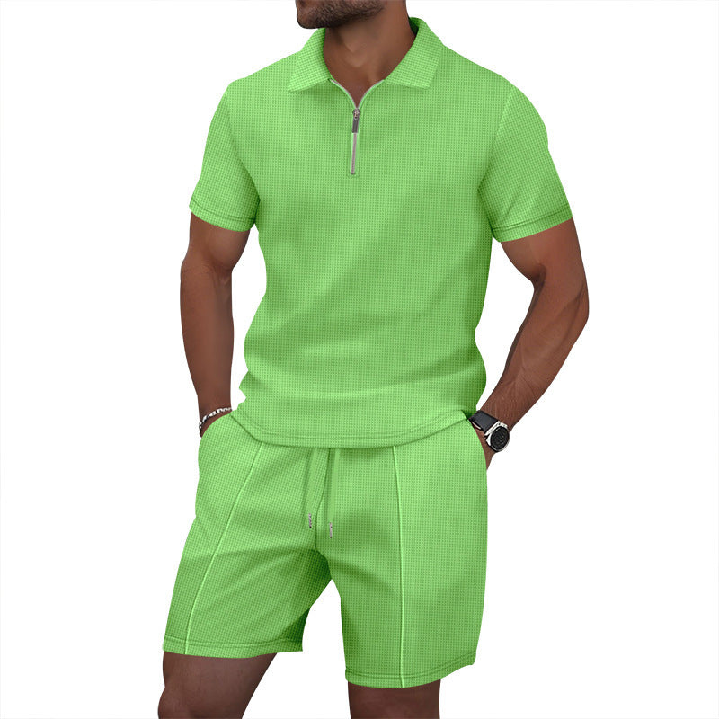 Person wearing a bright green polo shirt and shorts set on a white background