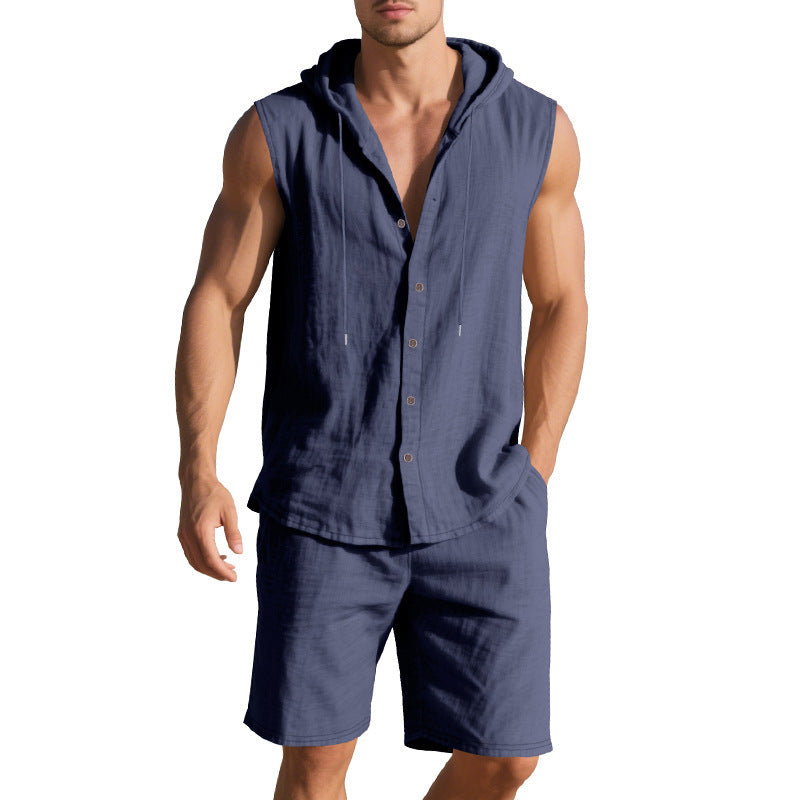 Man wearing a navy sleeveless shirt with a hood and matching shorts on a white background