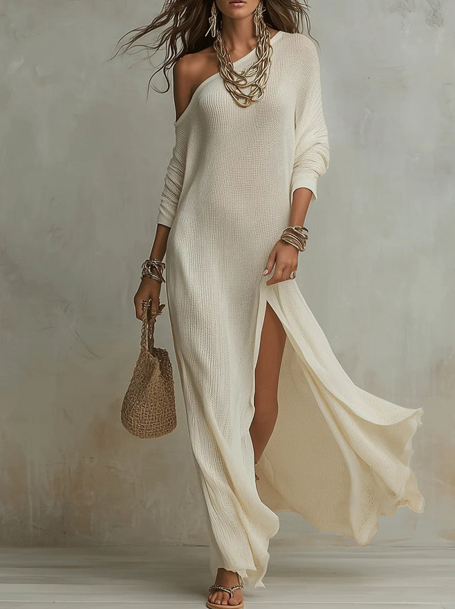 Woman wearing a flowing white dress with a neutral background