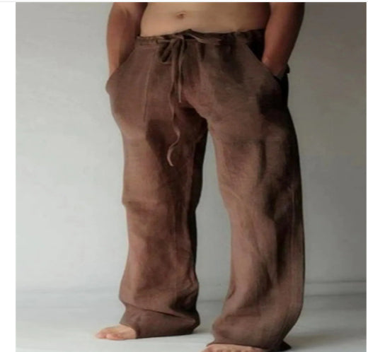 Brown baggy pants worn by a person on a plain background