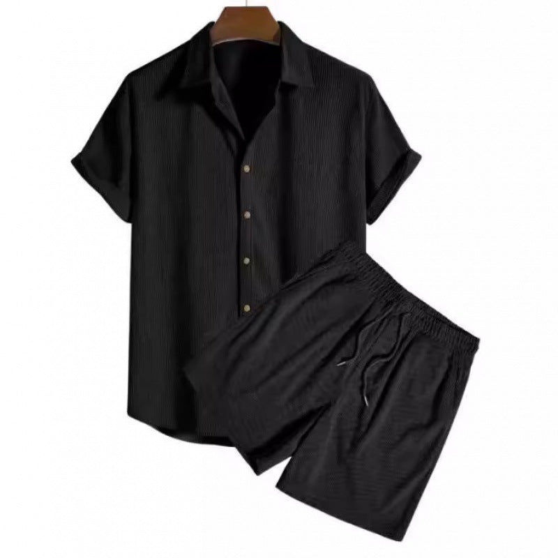 Black short-sleeve shirt and shorts set on a white background