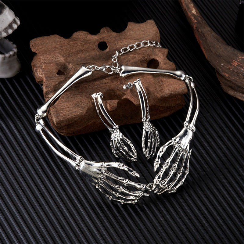 Silver skeleton hand bracelet on a dark textured surface