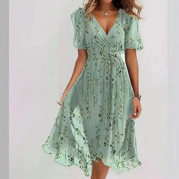 Green floral dress worn by a person on a white background