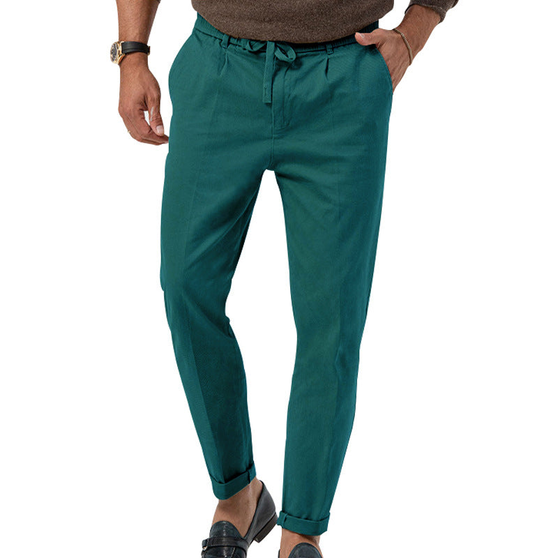 Teal pants worn by a person on a white background