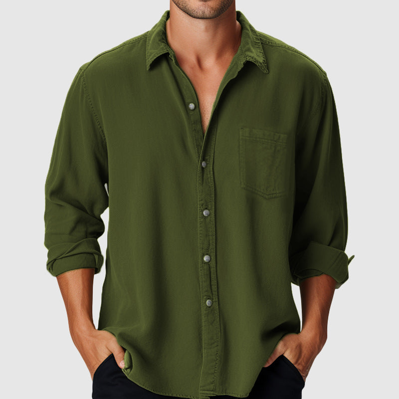 Green button-up shirt worn by a person on a plain background