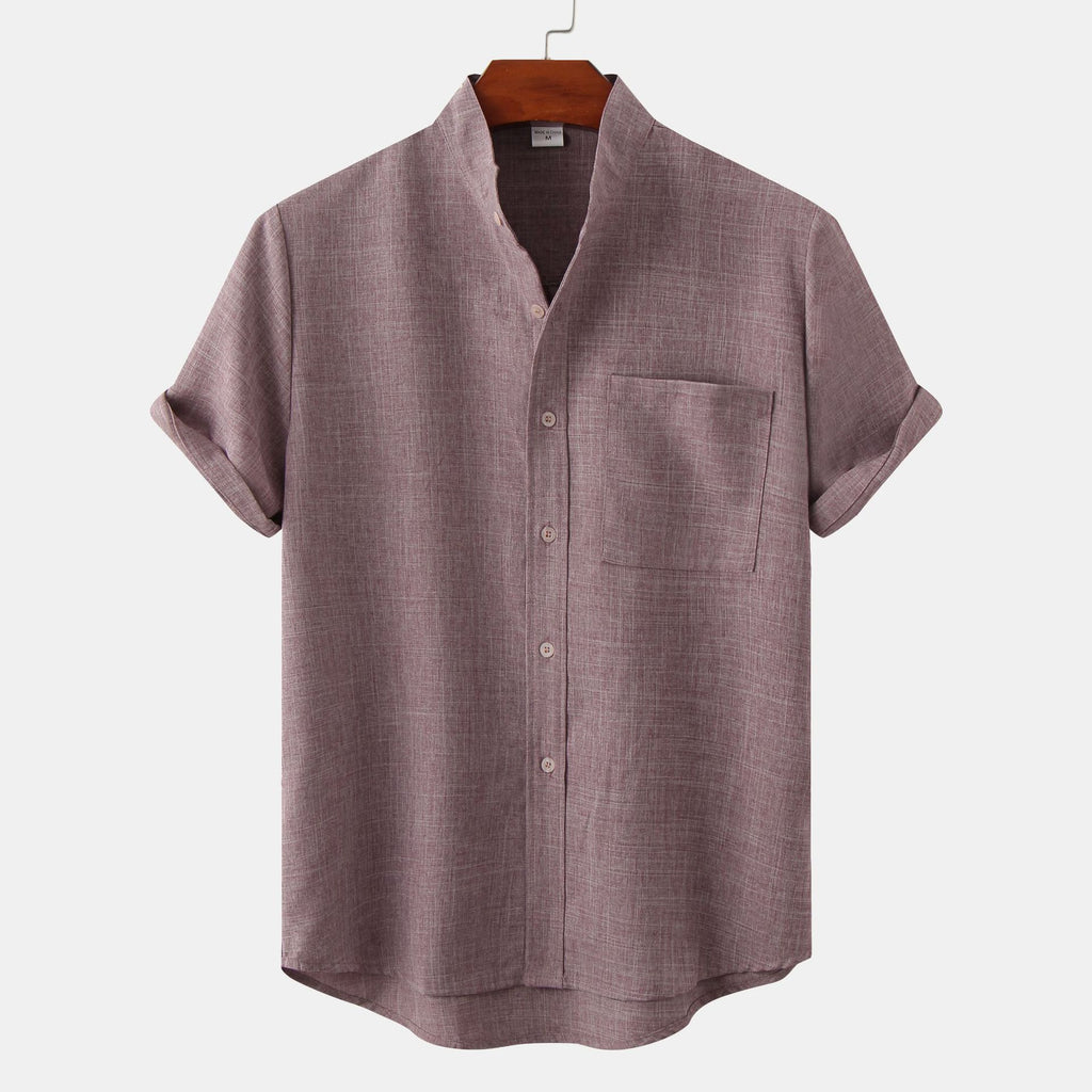 Purple short-sleeve shirt on a hanger against a white background
