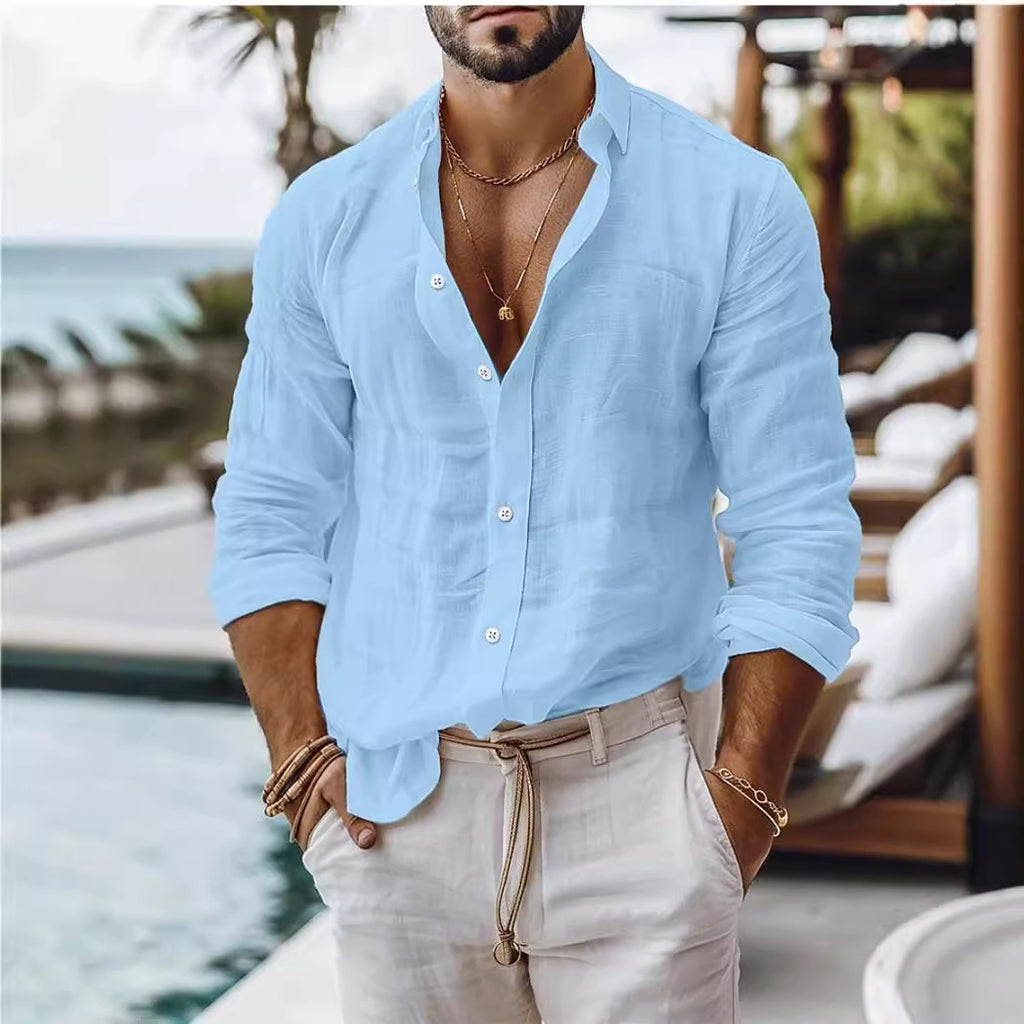 Man wearing a light blue shirt and beige pants by a poolside.