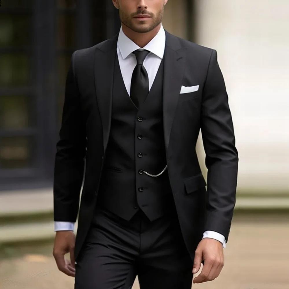 Man wearing a black suit with a white shirt and tie, standing outdoors.