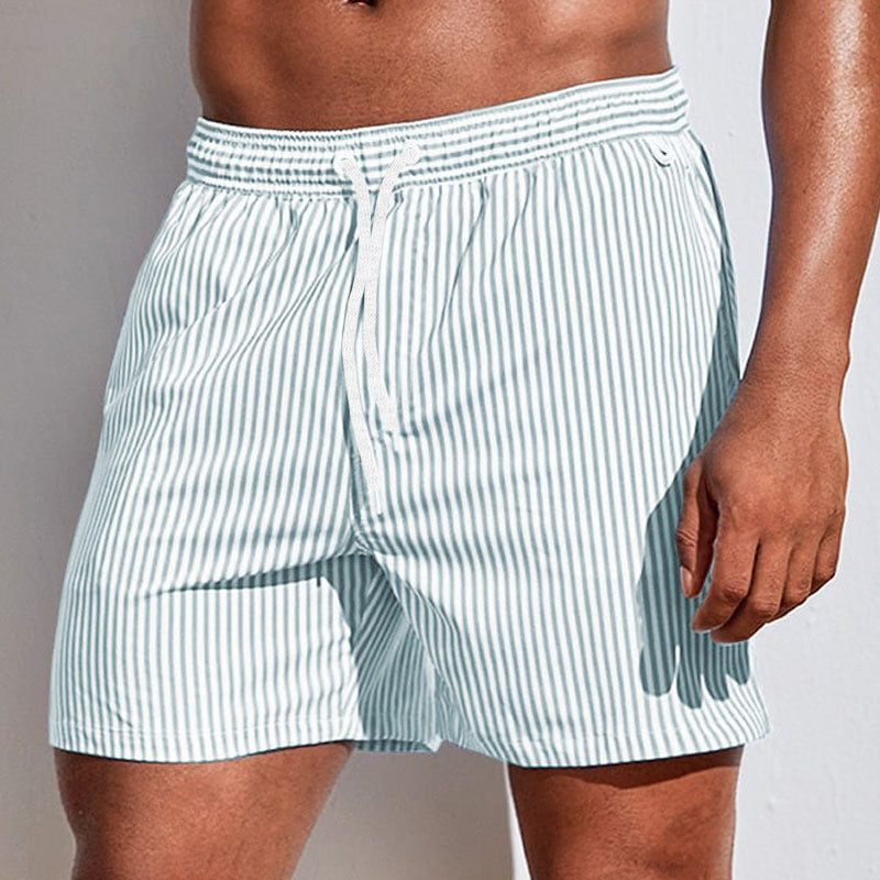 Light blue striped boxer shorts worn by a person on a plain background