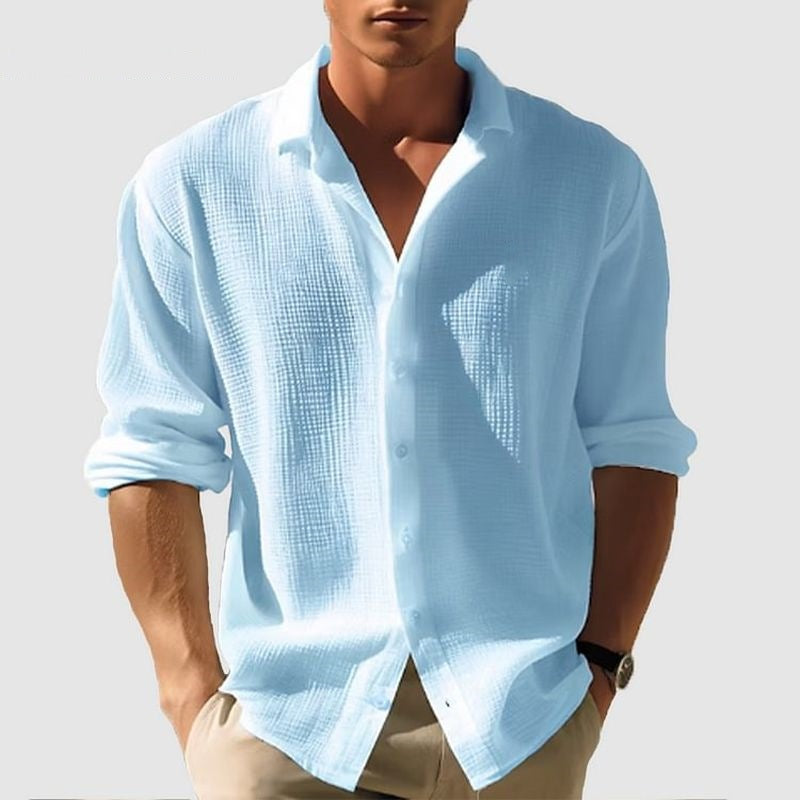 Light blue textured shirt worn by a person on a plain background