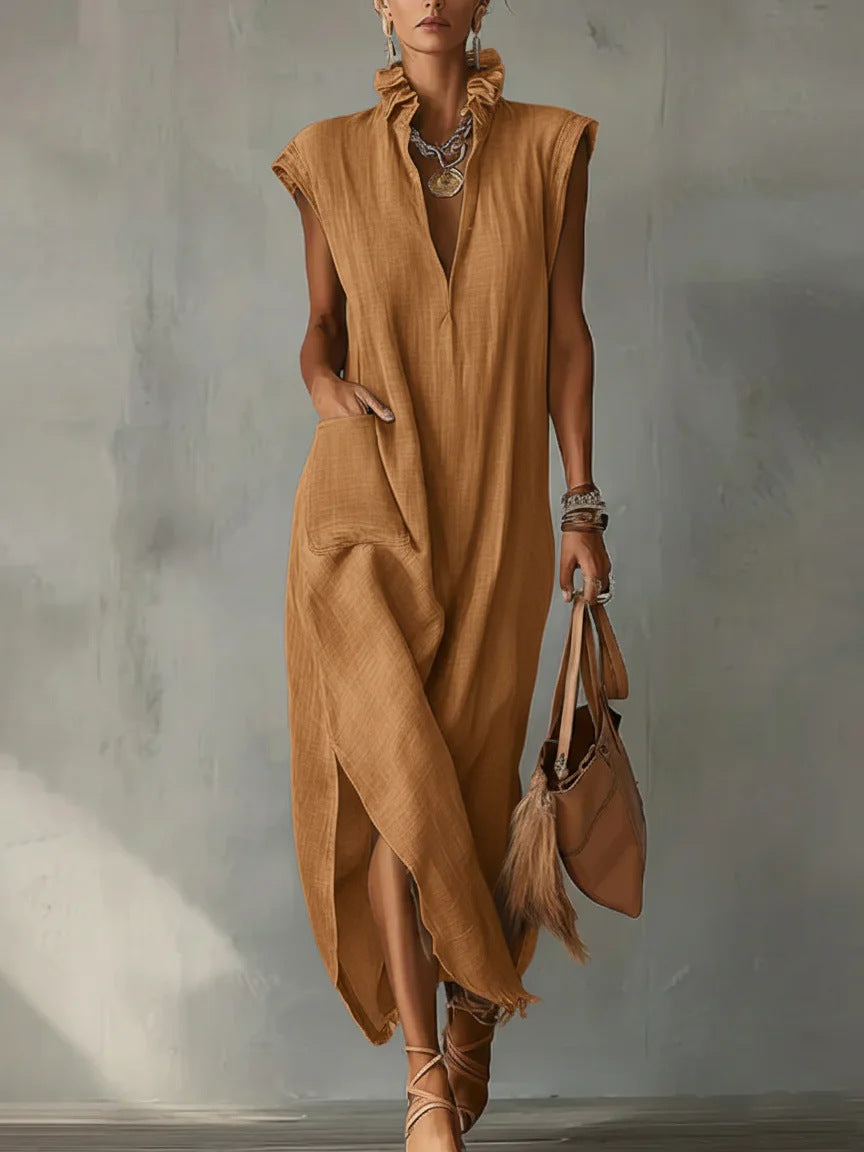 Woman wearing a brown dress holding a matching handbag against a neutral background