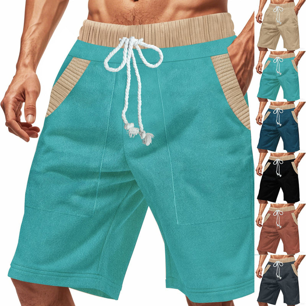 Teal shorts with beige drawstring and waistband on a white background