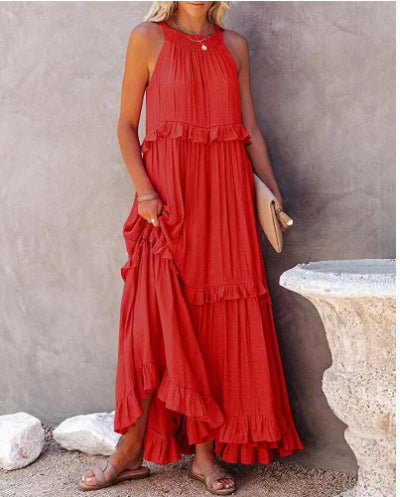 Woman wearing a red dress with ruffled layers against a neutral background