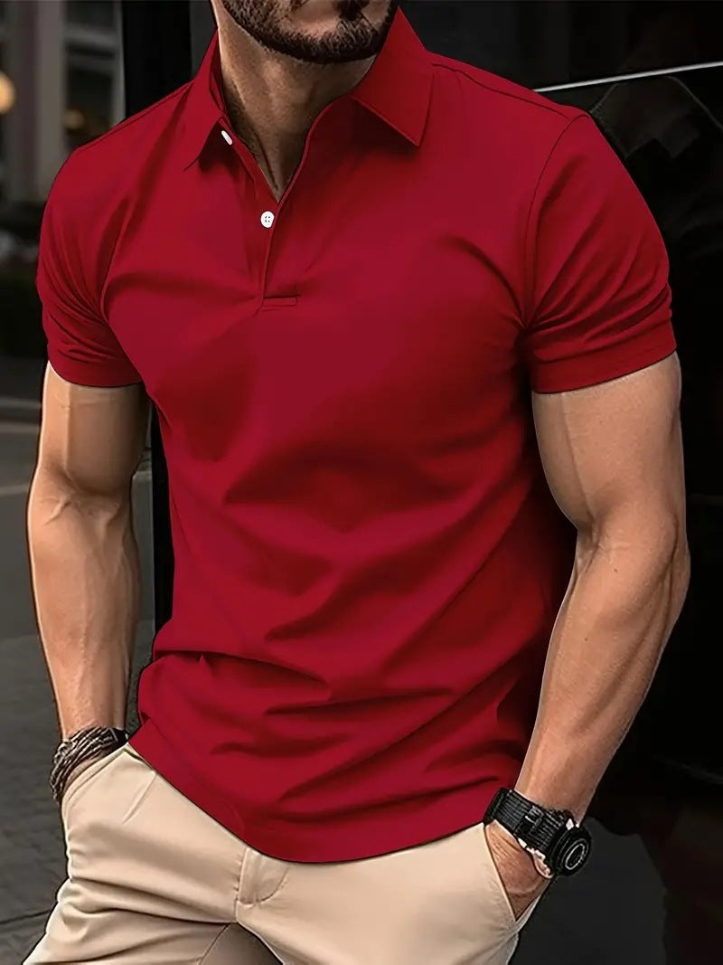 Man wearing a red polo shirt and beige pants with a blurred background