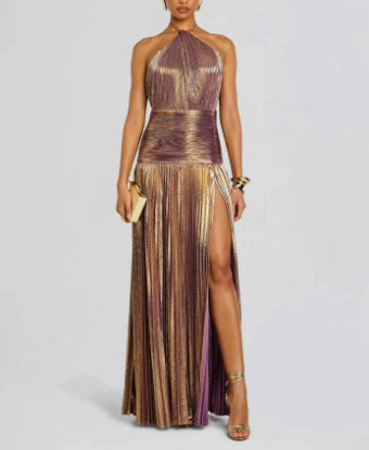 Woman wearing a metallic gold and purple dress with a slit on a light gray background