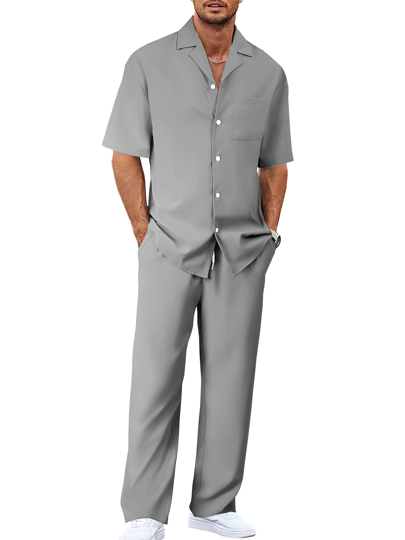 Man wearing a gray short-sleeve shirt and pants set on a white background