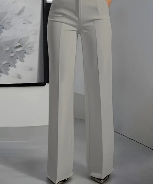 White pants on a mannequin against a plain background