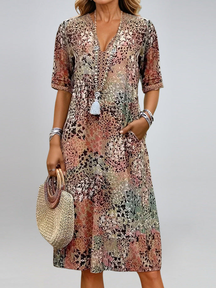 Woman wearing a floral dress holding a straw bag on a plain background