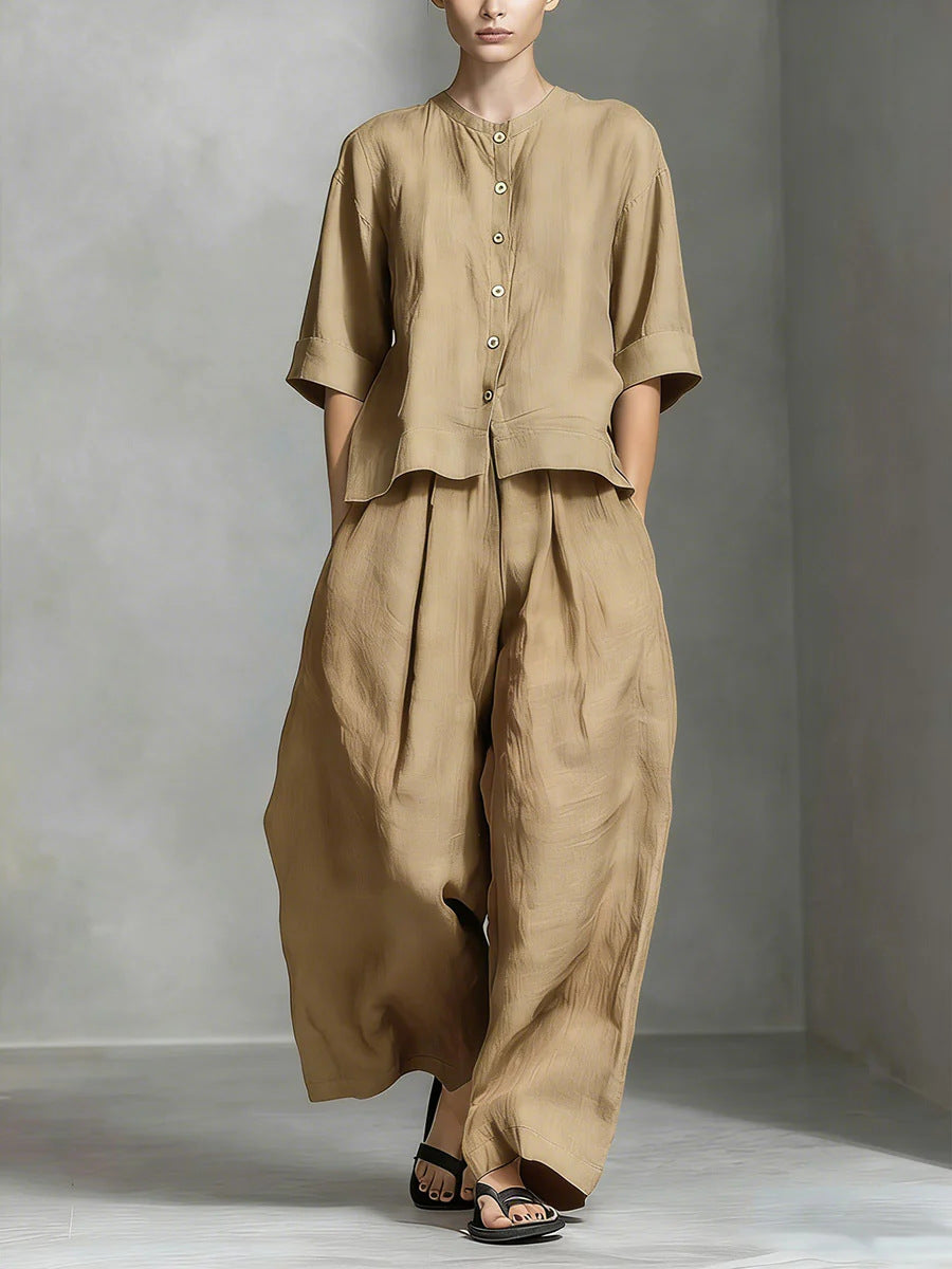 Person wearing a beige outfit with a plain background
