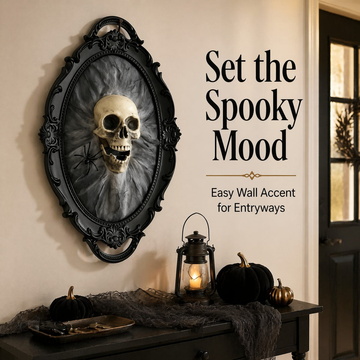 An ornate oval black wall mirror or framed decor piece featuring a skull and smoky gray background, displayed on a beige wall above a dark console table with pumpkins, a lantern, and cobweb decor. Text on the right reads, 'Set the Spooky Mood' and 'Easy Wall Accent for Entryways.
