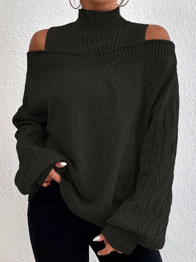 Black off-shoulder sweater worn by a person against a white background