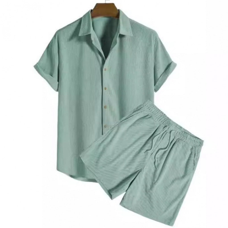 Light green pajama set on a hanger against a white background