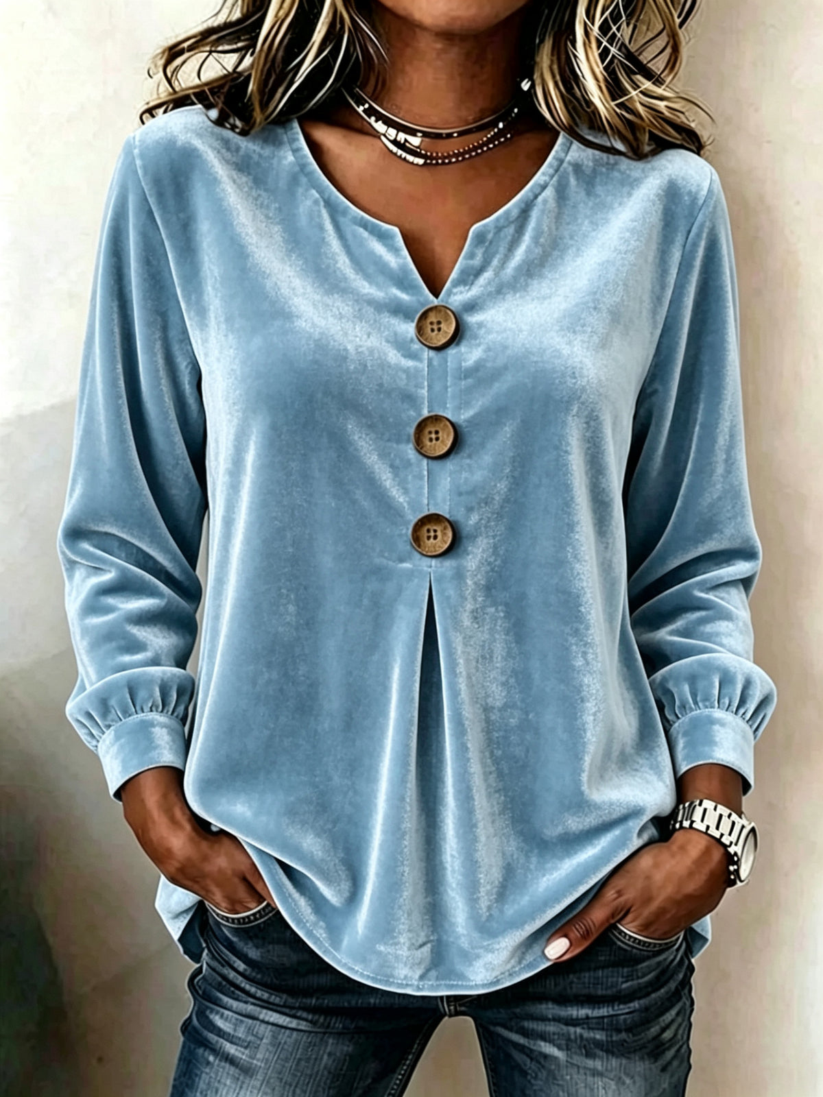 Light blue button-up shirt worn by a person against a neutral background