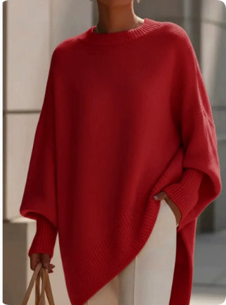 Person wearing a red sweater with a blurred background