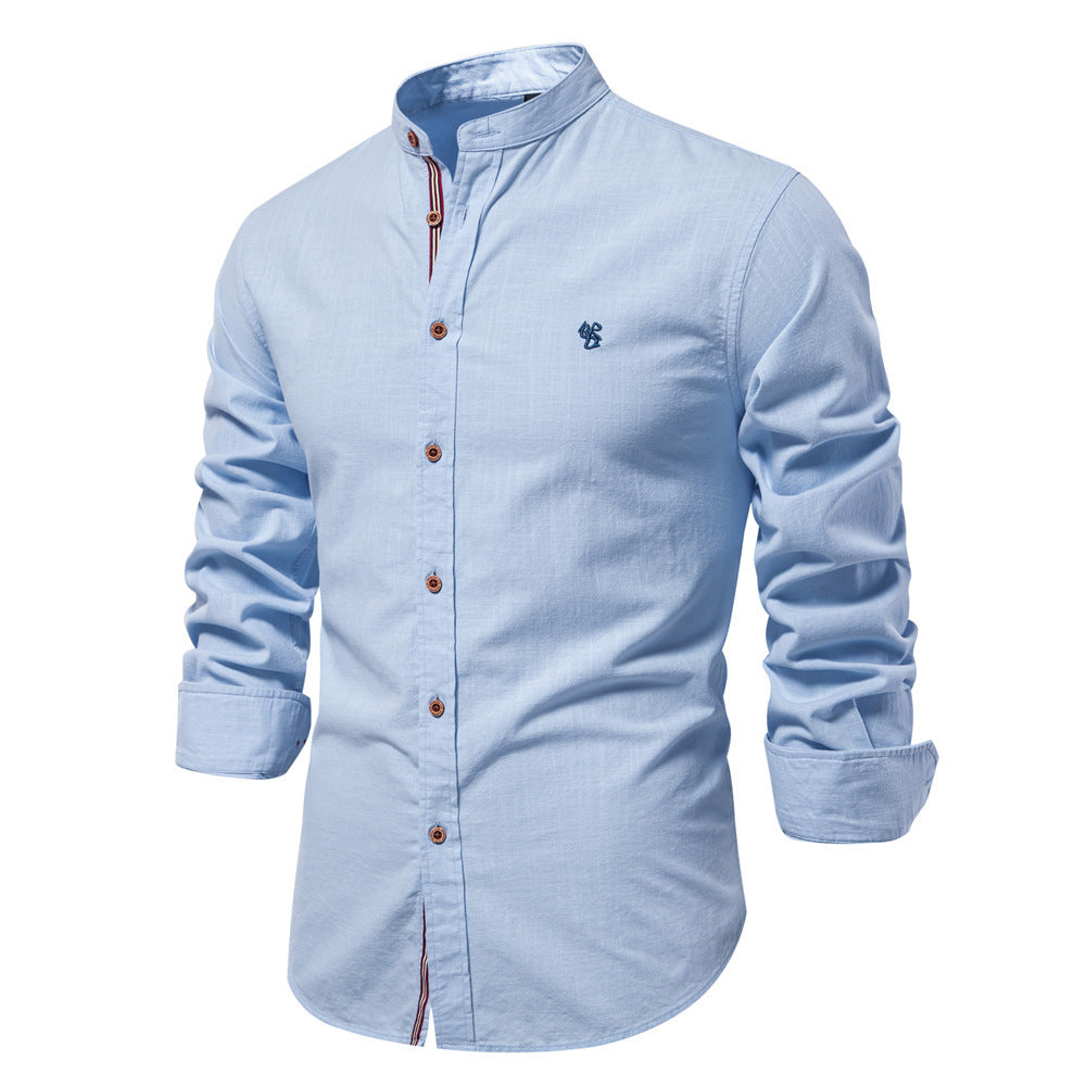 Light blue button-up shirt with a small logo on a white background
