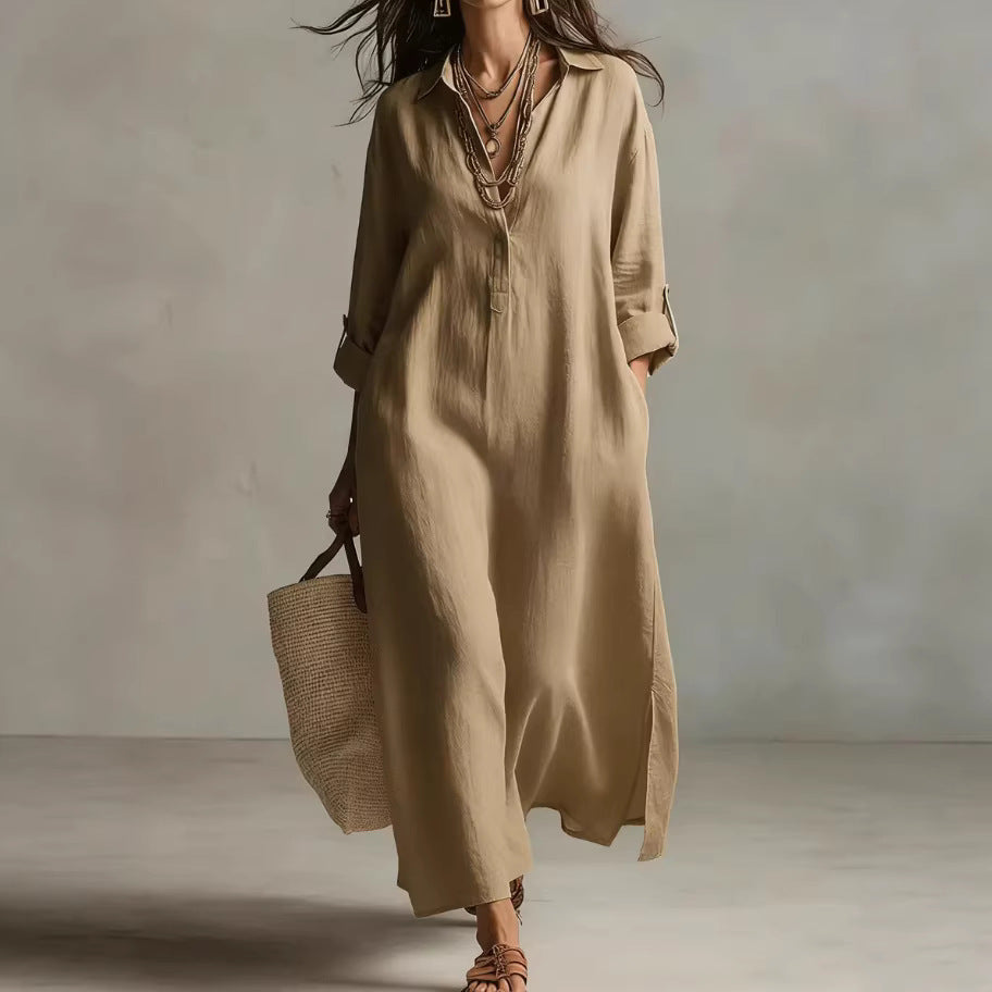 Woman wearing a beige long dress holding a woven bag against a neutral background