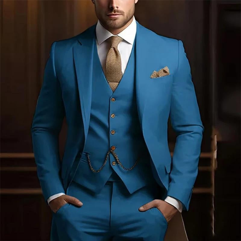 Man wearing a blue suit with a brown tie and pocket square against a blurred background