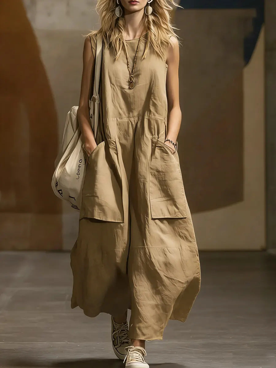 Woman wearing a beige sleeveless jumpsuit with a neutral background
