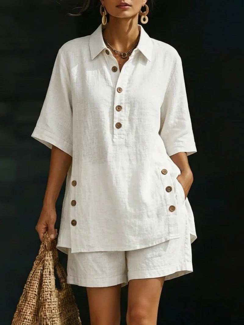Woman wearing a white linen outfit with brown buttons against a dark background