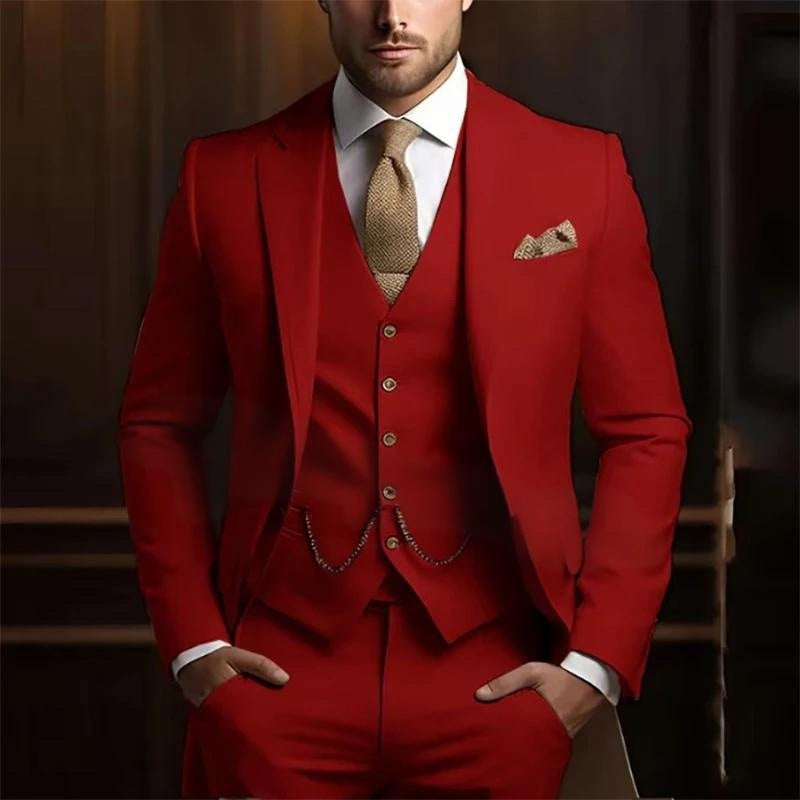 Man wearing a red suit with a white shirt and patterned tie against a dark background